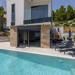 Villa Beachfront Luxury Luce, Featuring A Heated Pool, Fitness Area, And Sauna